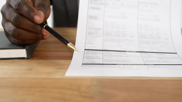 Policy agent sitting at desk holding insurance contract