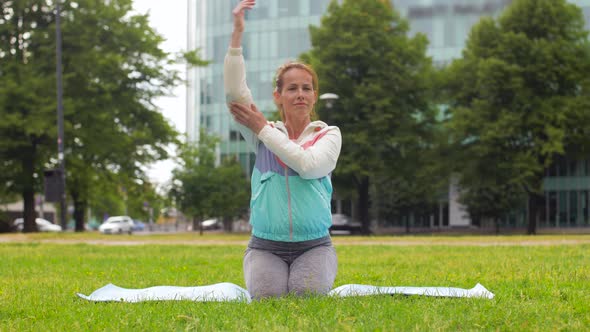 Woman Exercising on Yoga Mat at Park 