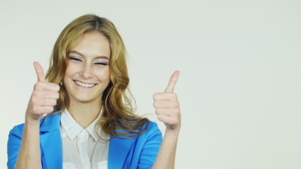 Attractive Woman Showing a Thumbs Up, Smiling, Approval Gesture