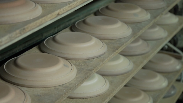 Industrial Production Of Porcelain Tableware .Plaster Molds For Plates On The Conveyor