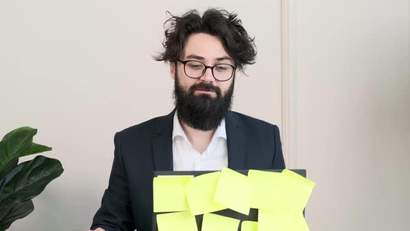 Bearded Man Having a Video Call Conference Trying to Explain Something