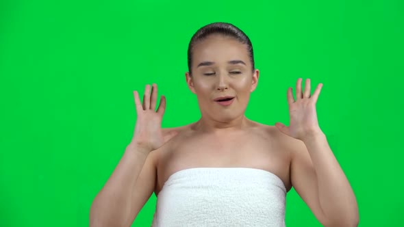 Scared Woman in White Towel with Face Expression on Green Screen at Studio. Slow Motion