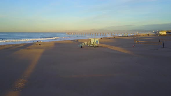 Aerial drone uav view of a lifeguard tower, pier, beach and ocean