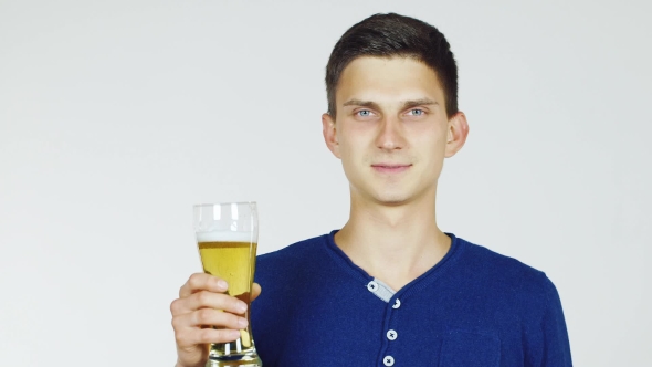 A Young Man With a Glass Of Beer On a White Background