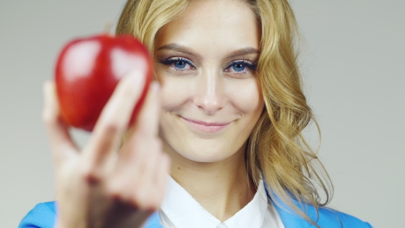 Portrait Of Attractive Blue-eyed Woman With Red Apple