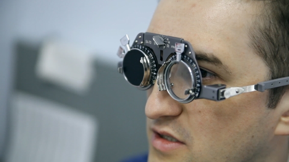 An Ophthalmologist Is Checking a Man's Vision