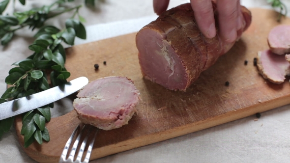 Man Is Cutting Slice Of Smoked Ham