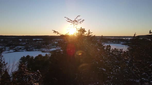 aerial  of a Winter sunset going towards sun  and city