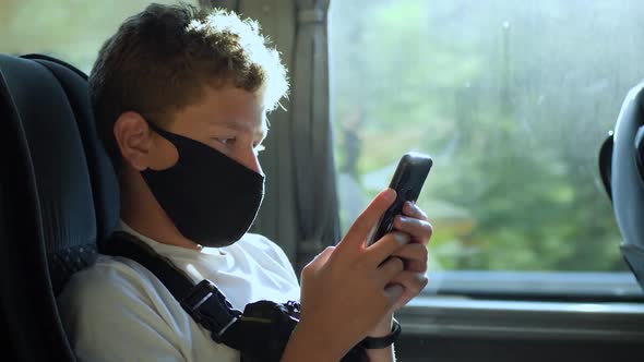 Boy Sits on Bus