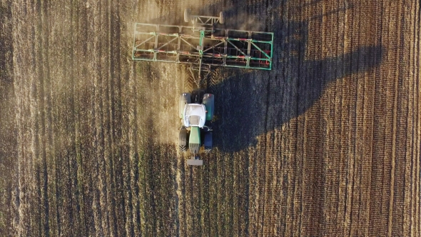 The Tractor Sows The Field. Top View Appears In The Frame