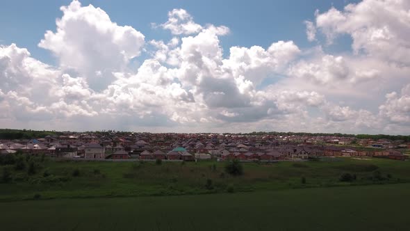 Many Private Houses in Field at Cloudy Day