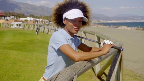 Young Woman Player On a Seafront Golf Course