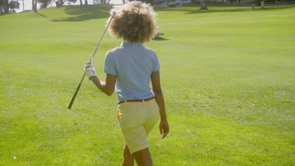 Young Woman Golfer Standing Looking Away