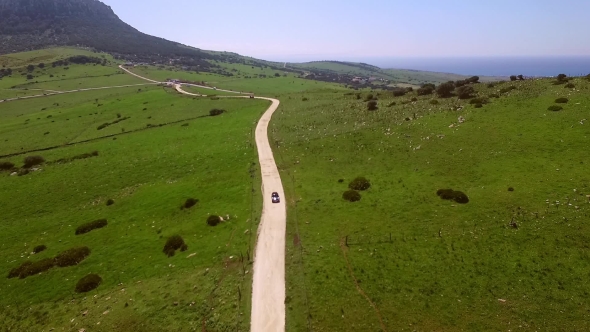 Aerial Of The Hilly Road With Driving Lonely Car