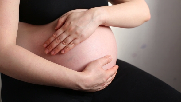 A Pregnant Woman Stroking Belly