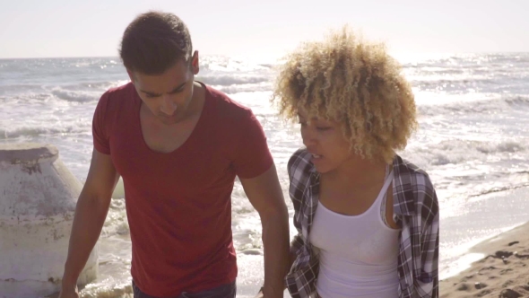 Young African American Couple Strolling On a Beach