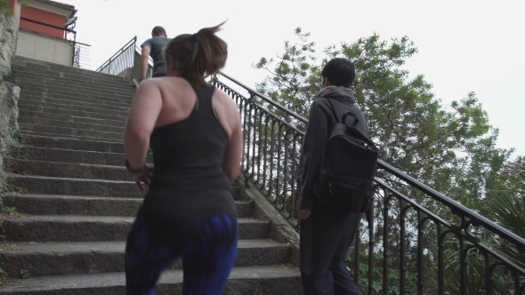 Runners Run Up The Stairs By Walking Women With Backpack.