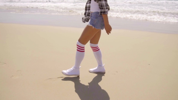 Young Sexy Woman Walking On The Beach.