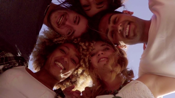 Low Angle View Of Five Friends In a Huddle