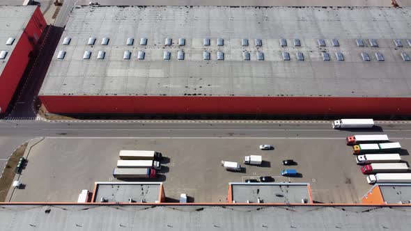 The white truck drives through the territory of the logistics center to load or unload cargo