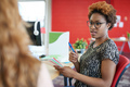 Unposed group of creative business people in an open concept office brainstorming. - PhotoDune Item for Sale