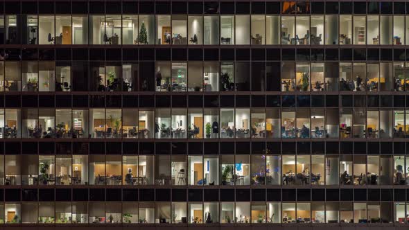 View of office windows with working people