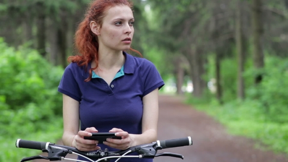 Woman Use of the Smart Phone and Riding a Bike