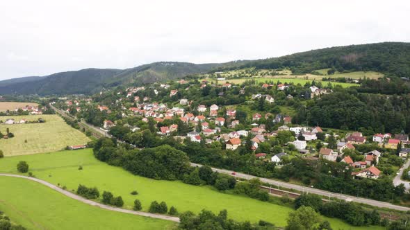 Aerial Drone Shot  a Picturesque Town in a Hilly Rural Area  Drone Flies in a Curve