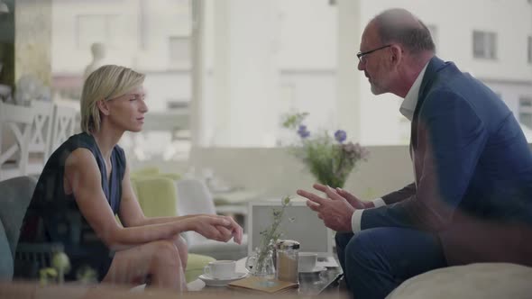 Businessman and woman having a meeting in coffee shop