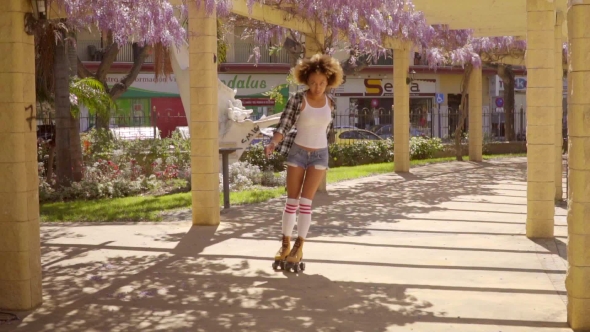 Young Woman Roller Skating Down An Arcade