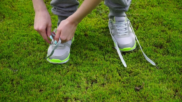 Girl Stopped Running To Tie The Laces On Running Shoes. Fitness Girl Training Outdoors