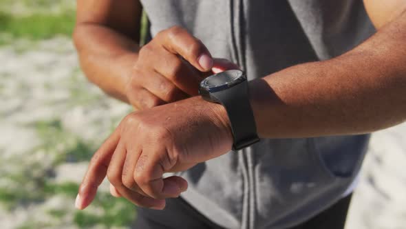 Senior african american man exercising using smartwatch listening to music