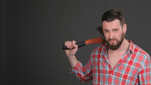 Bearded Hipster Puts An Ax On His Shoulder