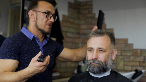 Cozy Barbershop, Is Engaged In a Professional Stylist Haircut Men Aged.