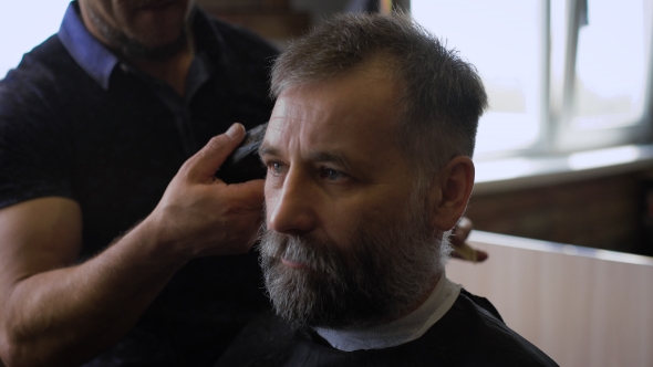 Stylish Barber Works With The Haircut