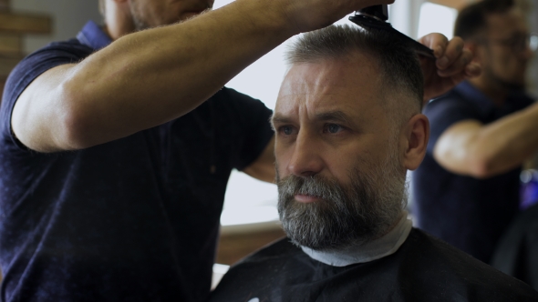 Professional Stylist Is Making Haircut For Aged Men
