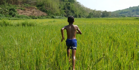 Poverty Boy Running In Grass alt