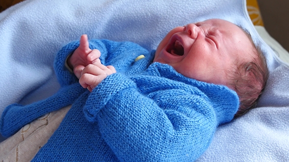 Newborn Baby Crying On The Bed