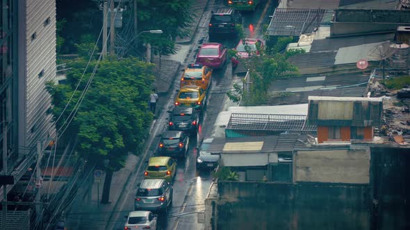 Cars Passing Slums On Rainy Day