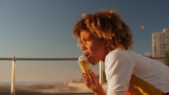 Little boy eating ice cream at sunset