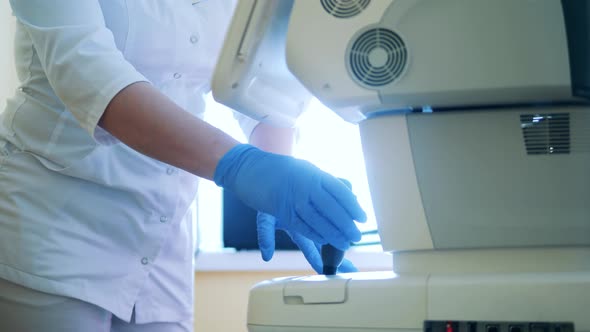 Doctor is Operating a Machine for Eyesight Examination