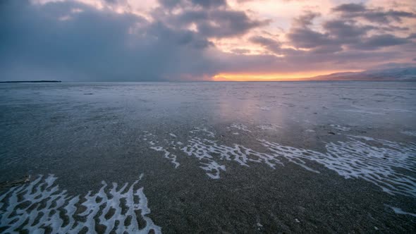 Time lapse over frozen landscape as the sunsets