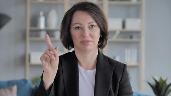 Portrait of Old Businesswoman Waving Finger to Refuse