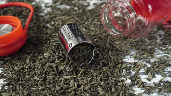 Stainless Steel Teapot Basket in a Pile of Dried Green Tea Leaves