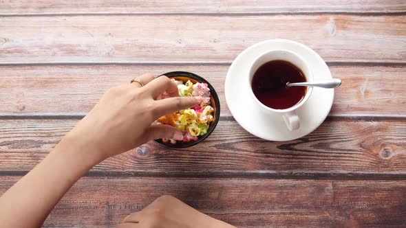 Women Hand Holding a Bowl of Colorful Popcorn