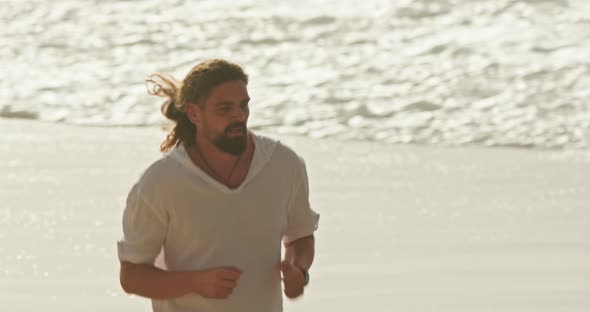 Footage of a Man Jogging Along the Shore