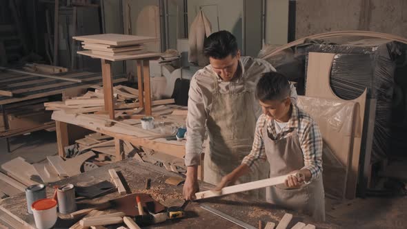 Boy Learning Carpentry With Father