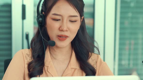 Businesswoman Wearing Headset Working Actively in Office