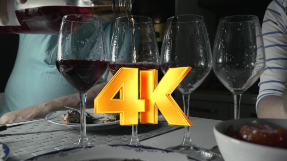 Man Pouring Red Wine In Four Glasses