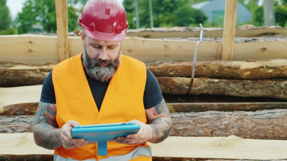 Brutal Builder Or Worker Uses a Tablet In a Break From Work